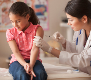 Doctor giving child patient injection