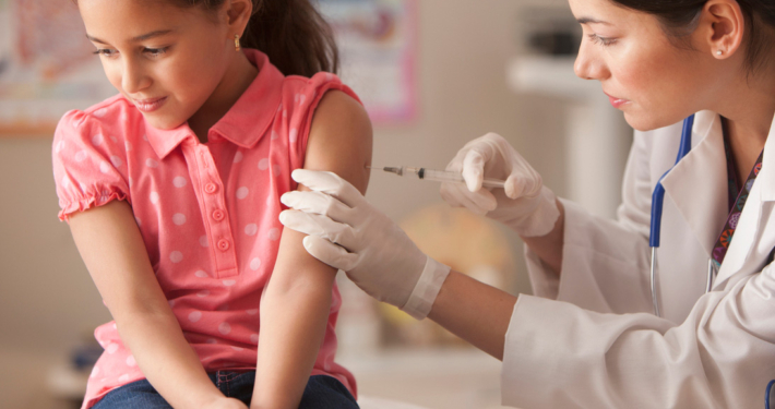 Doctor giving child patient injection