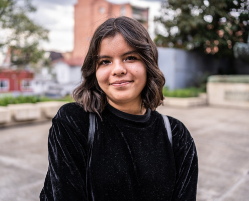 Portrait of a young university woman student outdoors